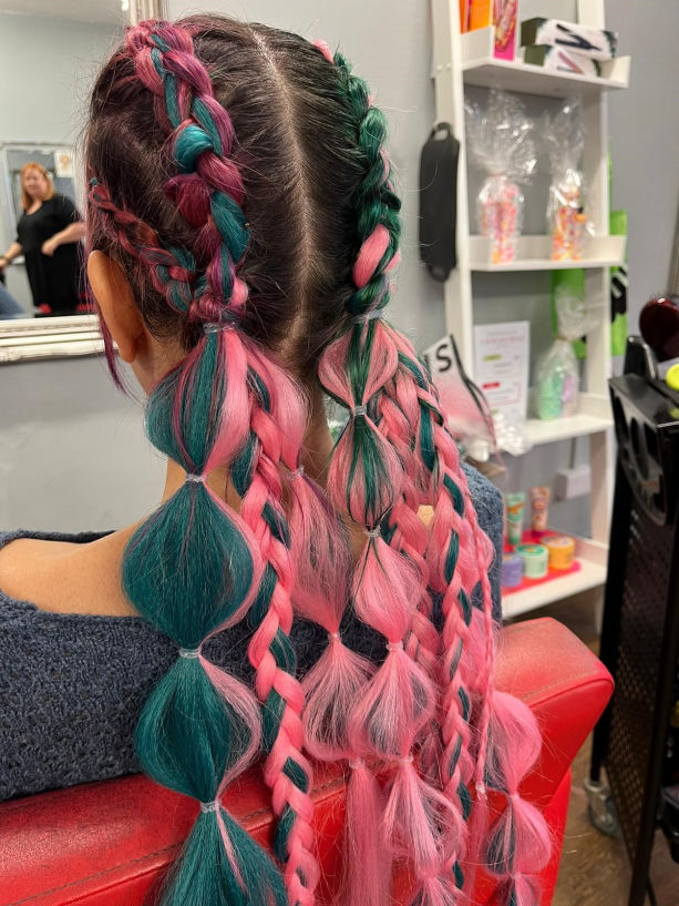 Braiding with added coloured hair extensions